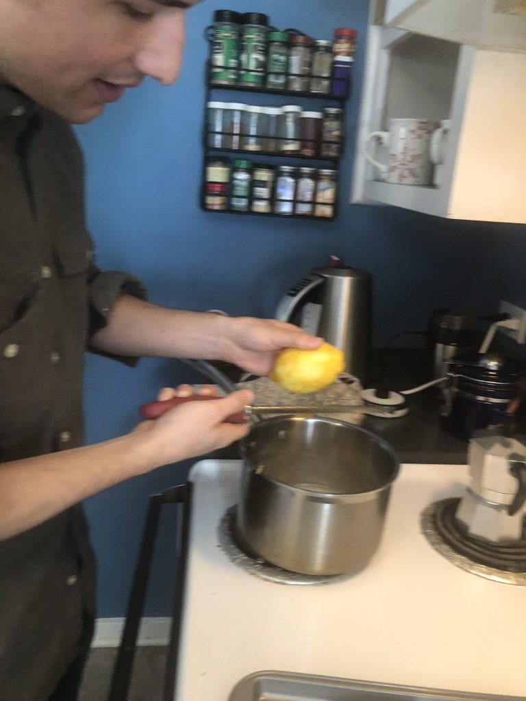 zesting a lemon into the pot.