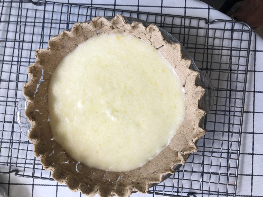 a tall oat crust pie shell filled with a small amount of lemon filling