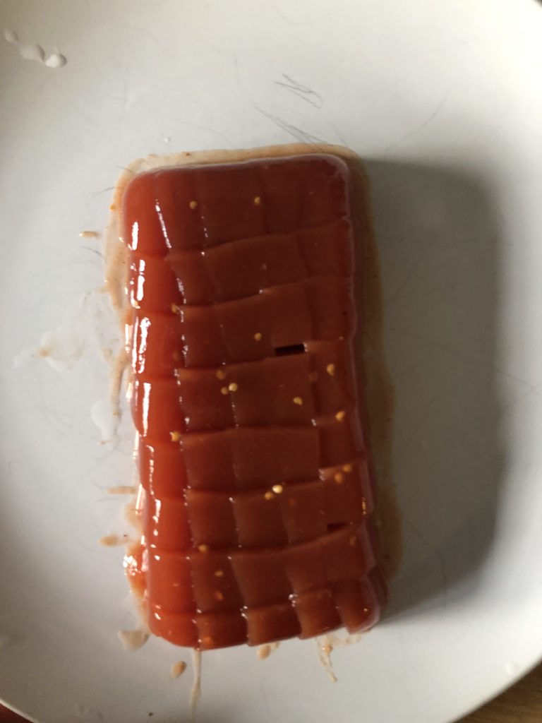 A block of tomato aspic, very smooth, cut into cubes.