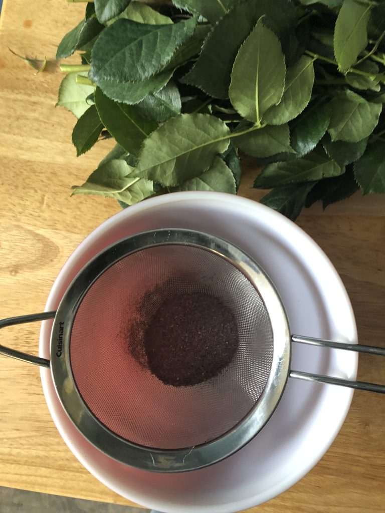 dark purple powder in a sieve.