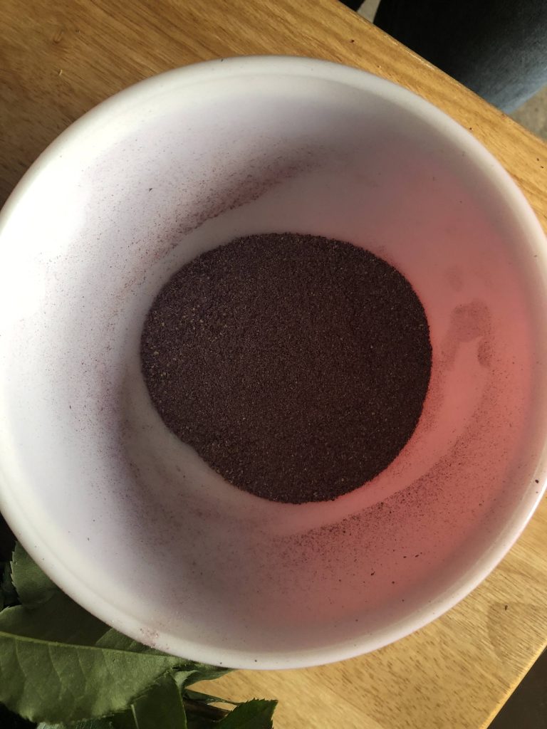 Dark purple powder in a bowl